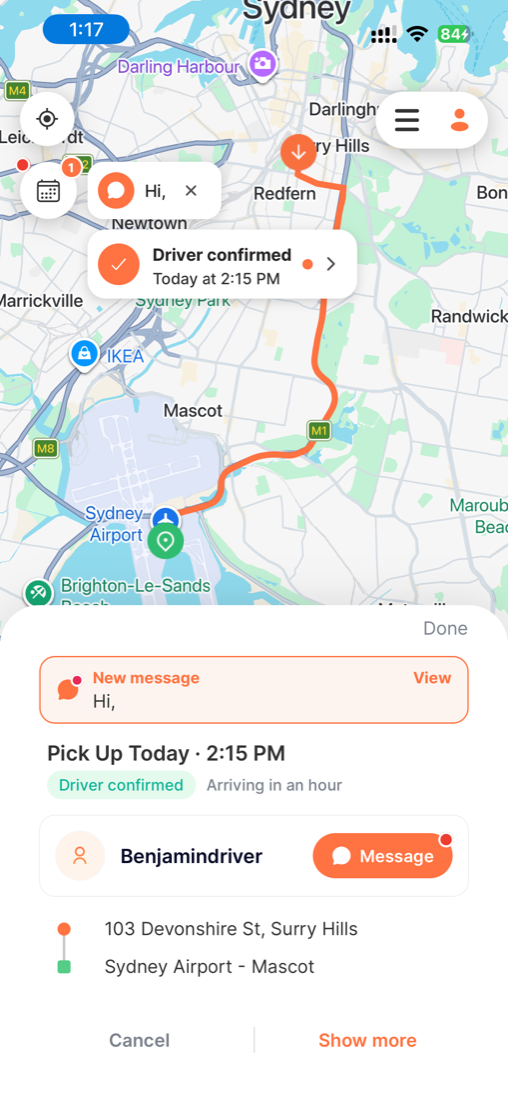 Scheduled ride screen with a highlighted 'New message - Hi,' alert and a View button, a green 'Driver confirmed' badge, 'Arriving in an hour', the driver's name with a Message button showing an unread dot, and the pickup and drop-off.